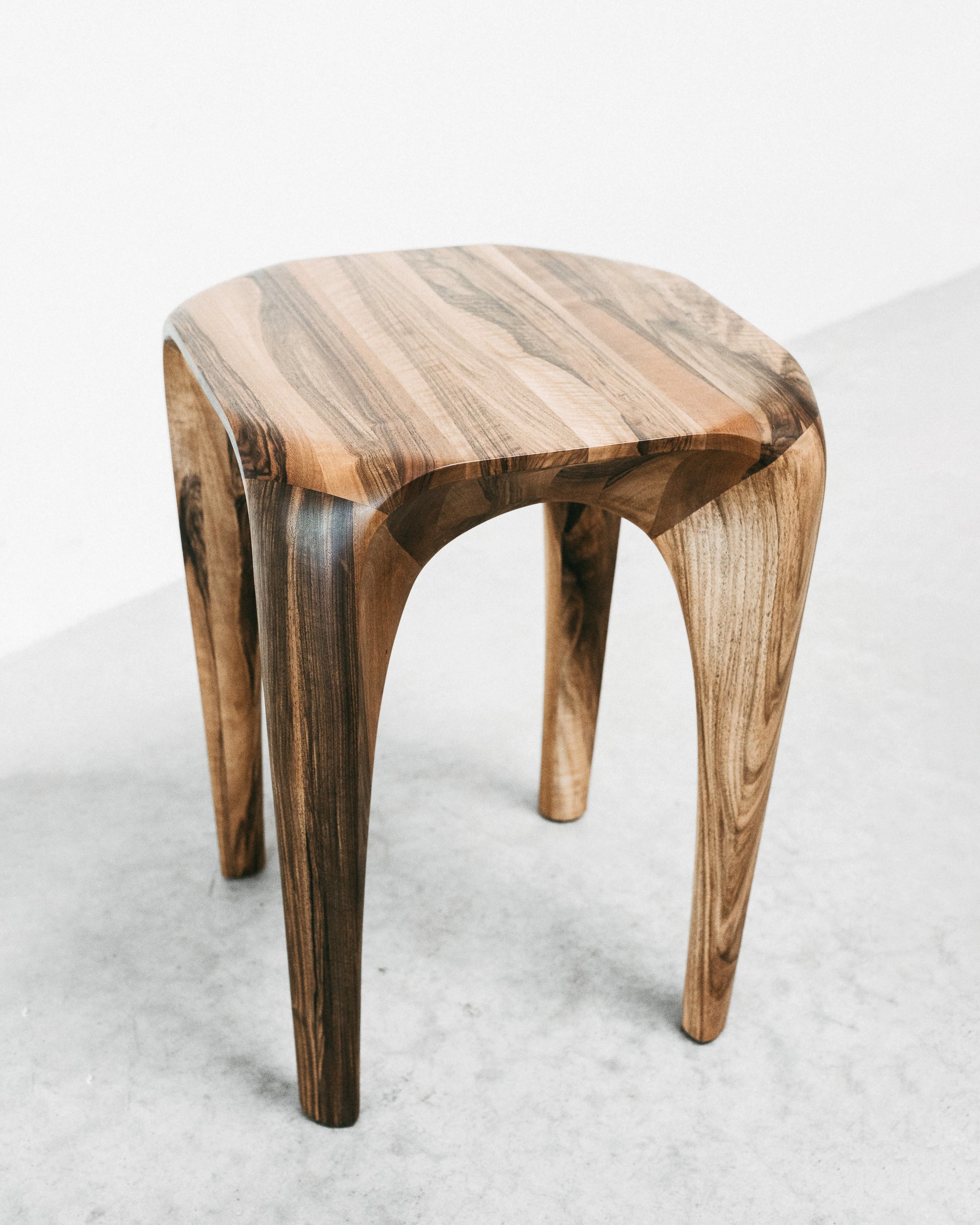 La collection Spline est à mi-chemin entre mobilier et sculpture. Elle s'éloigne des formes géométriques et rectilignes pour tendre vers des lignes naturalistes en quête de fluidité et de continuité. Les meubles sont à regarder, à toucher et à ressentir. Chaque pièce est unique, faite à la main, signée et datée. Autres dimensions et essences de bois sur demande.