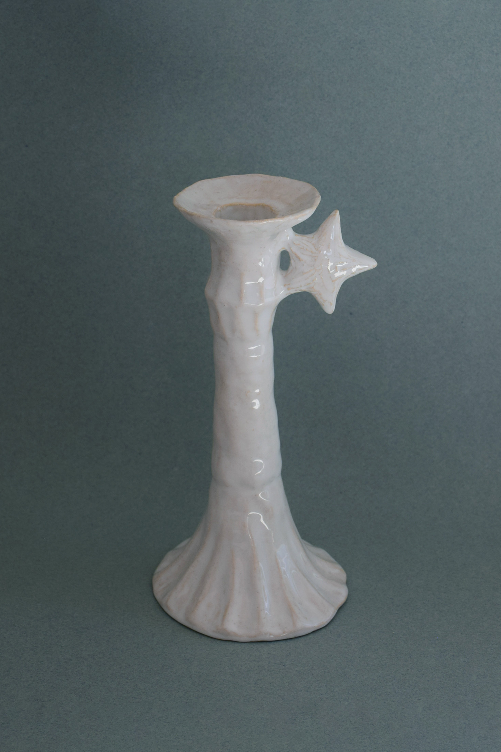 Le Grand Chandelier, issu de la collection Pierrot, évoque l’univers tendre et mélancolique du célèbre clown rêveur. Son modelage, tout en douceur, rend hommage à la nuit et à ses étoiles en s'inspirant de la célèbre comptine Au Clair de la Lune. Qu’il éclaire une table de chevet ou un coin de salon, Le Grand Chandelier incarne une poésie discrète. Façonné entièrement à la main, chaque bougeoir présente des irrégularités subtiles qui témoignent d'un geste instinctif.

Pièce unique, fabriquée à la main