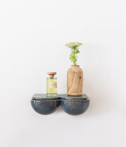 L'étagère, véritable pièce créative, aux lignes harmonieuses et généreuses saura habiller votre mur. En table de chevet ou dans votre entrée, en solo, duo ou trio... les combinaisons sont nombreuses et donnent libre cours à votre imagination. Ses rondeurs et son émail brillant couleur bleu lazuli lui donnent une allure douce et des airs de bijou artisanal. &nbsp;  Petite subtilité, une niche se cache sous la tablette amovible et fera office de rangement pour vos trésors, apportant une double.